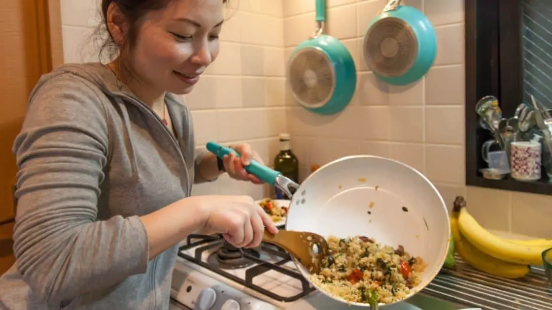 Woman Pouring Cooked Food