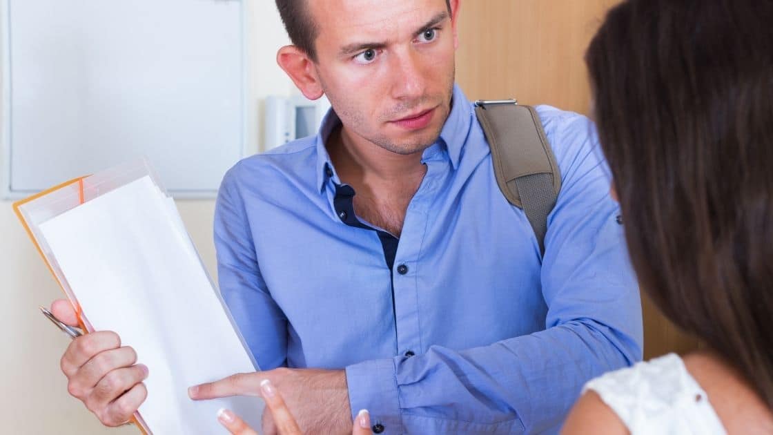 Man In Blue Shirt Shows Paper